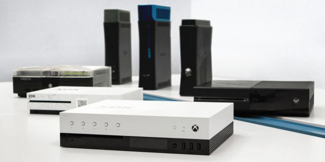 Microsoft's Project Scorpio dev kit (center), along with older Xbox models' dev kits